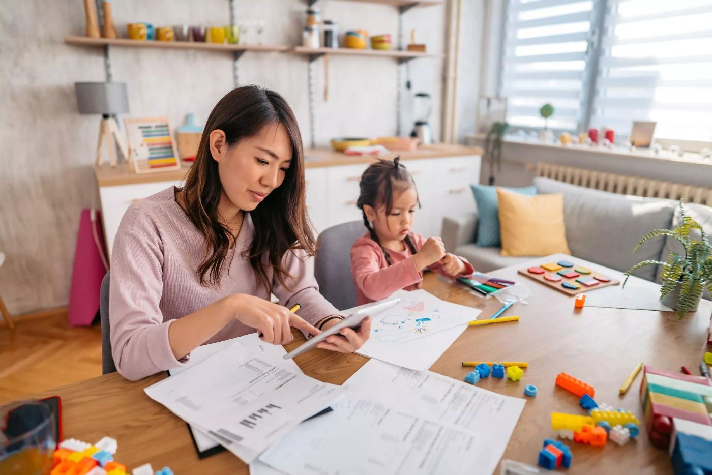 Parent reviewing family finances and tax documents at home