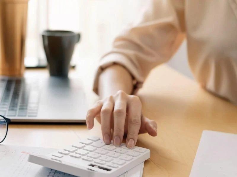 Close-up of a bookkeeper's hands reviewing a financial report